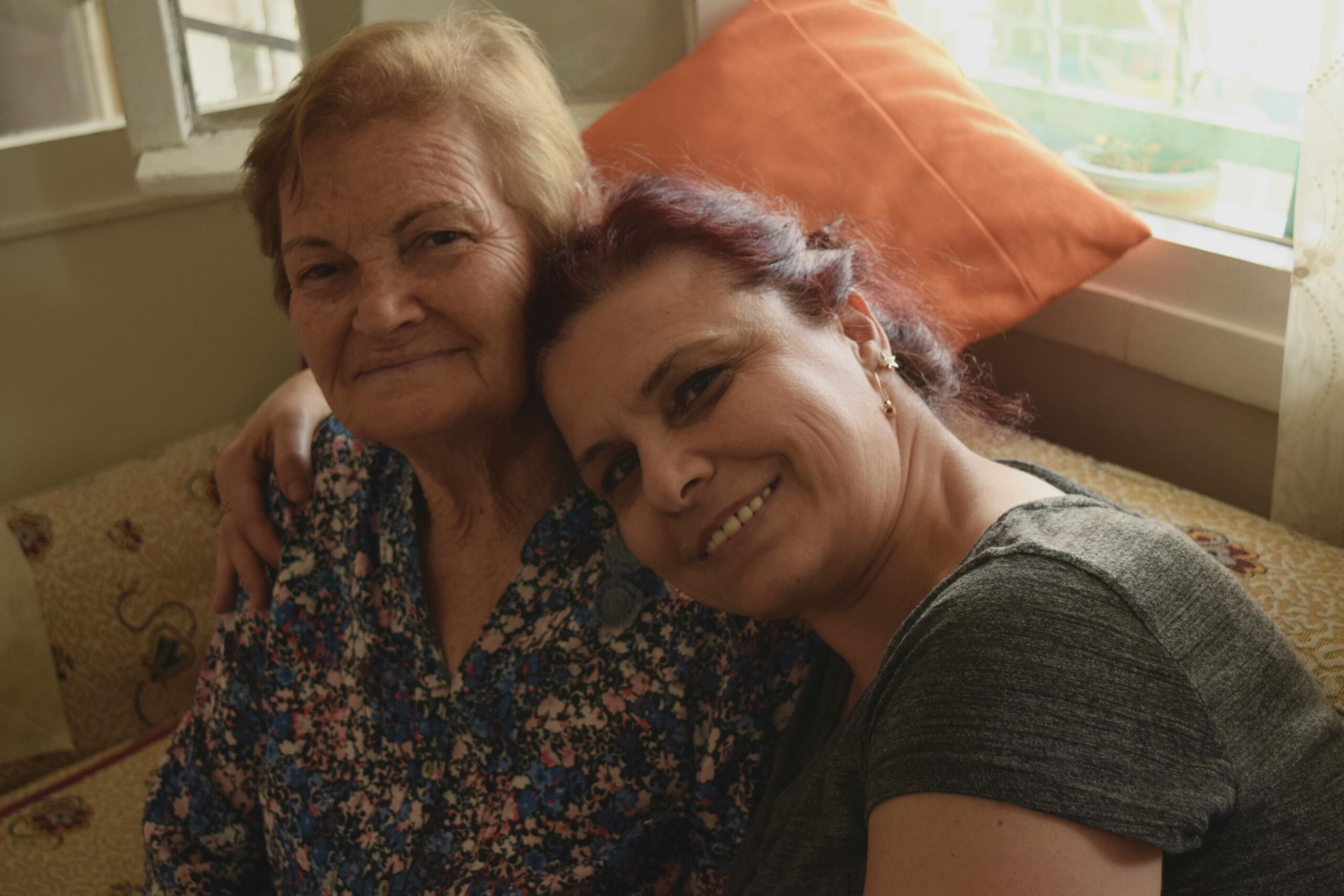 A heartwarming moment shared between two women, radiating love and joy indoors.